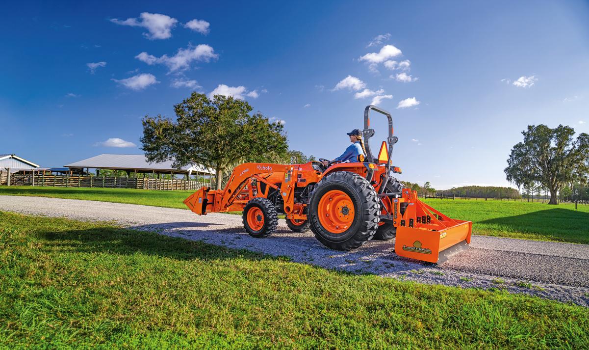 woman grading driveway with L4802